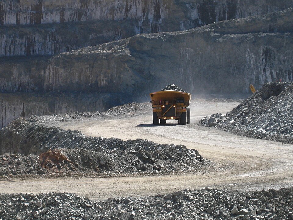 Split image showing gold mining operation and physical gold bars representing two investment approaches
