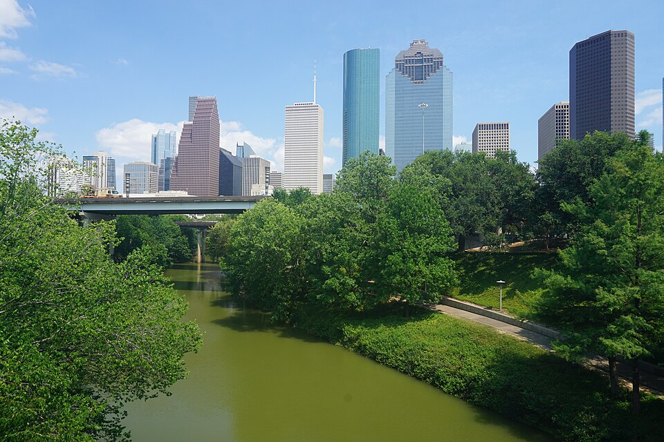 Houston Texas skyline with gold and silver bullion coins representing local precious metals buying