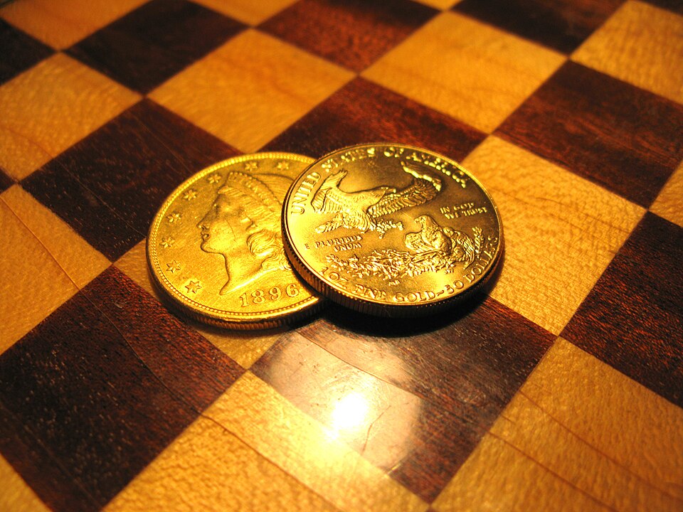 Stack of physical gold bars and silver coins representing tangible wealth